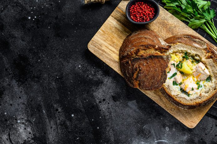 Salmon soup served in bread. Creamy hearty fish soup. healthy an